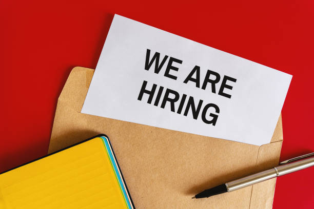 istock Hiring Announcement on White Paper Inside an Envelope on Red Background and Office Stationery 1484817487
