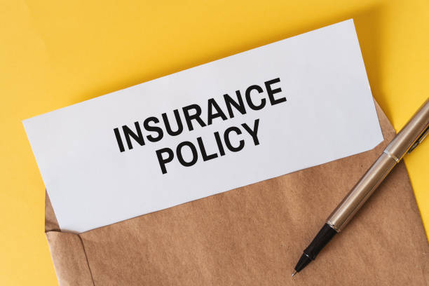 istock Insurance Policy Document on White Paper Inside an Envelope on Red Background with Pen 1484817494