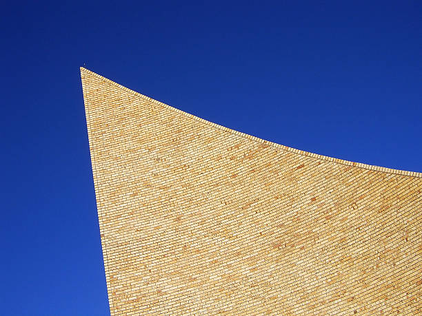 Face brick tower against a deep blue sky stock photo