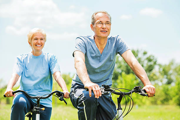 istock Cheerful mature couple riding bicycles in park. 148482050
