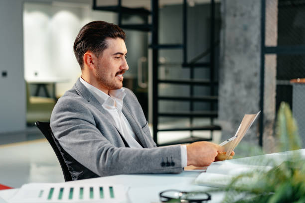 istock Young arab businessman working at the table in modern office 1484822697