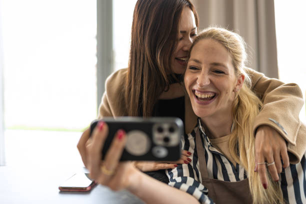 istock Smiling female friends taking a selfie together. 1484824817