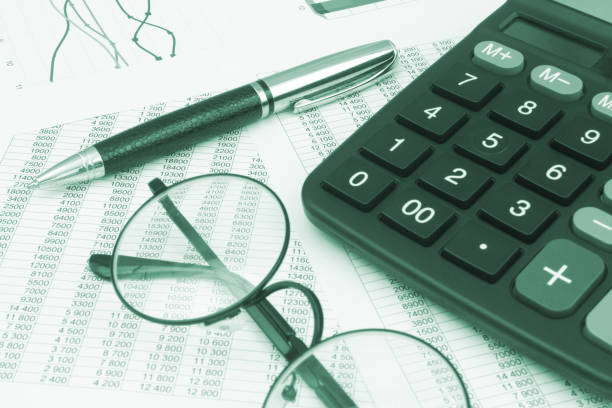 istock Calculator, pen and eyeglasses on financial papers. 1484825178