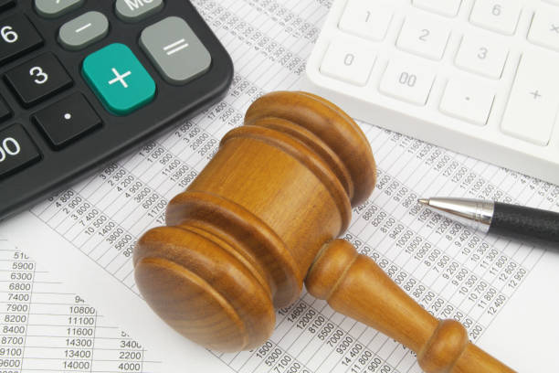 istock Calculators, pen and judge gavel on financial documents. 1484825314