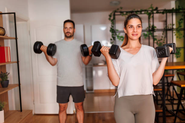 istock Couple weightlifting while working out at home 1484825422
