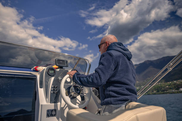istock Mature man piloting boat on a sunny day 1484826847