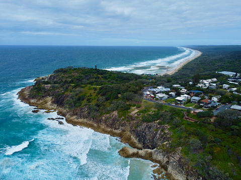Aerial Drone view of beach houses and residential homes on North Stradbroke Island. Rental accommodation and holiday homes with ocean views on a sunny day in Queensland, Australia.
