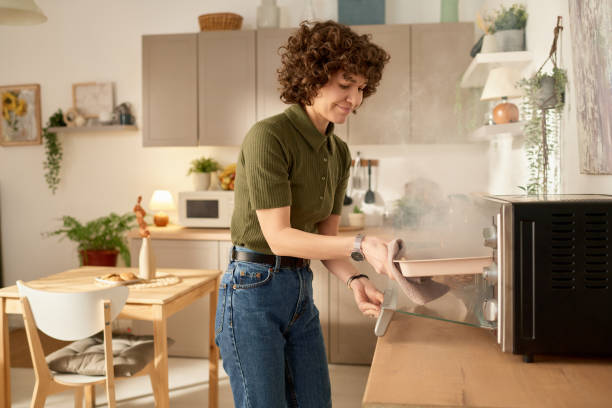 Housewife burning food in the oven stock photo