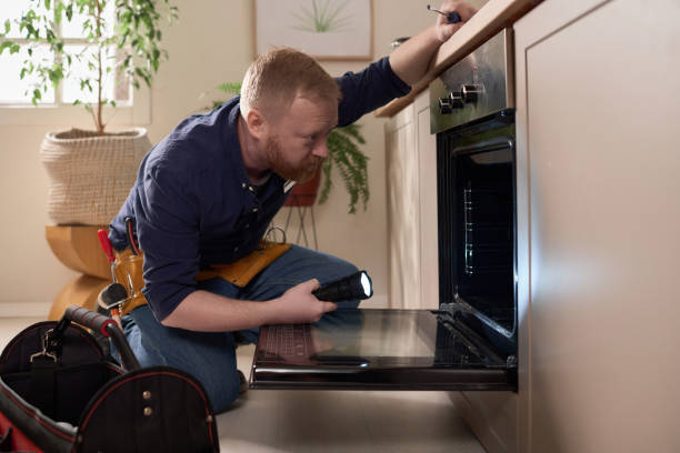 istock Repairman examining the oven in the kitchen 1484829802