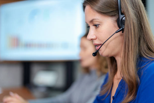istock Call center operators answer the phone to assist customers in using the service. Close up of Call center woman wearing headset with microphone talk with customer and answer question in the office. 1484830072