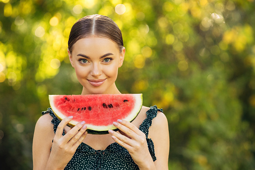 Beautiful girl enjoying watermelon