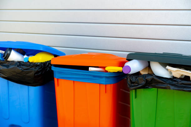 istock Three trash containers full of garbage near the building 1484833055