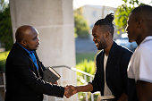 Pastor welcomes smiling young man into Church