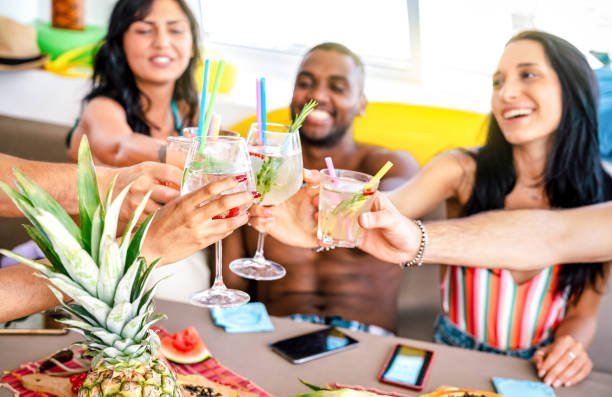 trendy people toasting fancy cocktails at boat party trip - young millenial friends having fun on luxury vacation - travel life style concept with vacationer sharing aperitif drink with tropical fruit - dining nautical vessel recreational boat europe imagens e fotografias de stock