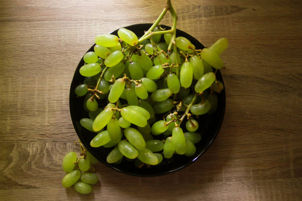 istock Green grapes on the black plate 1484835153