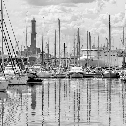 Genoa, Italy - april 02, 2023 : Black and white view of Genoa Marina with its  lighthouse and boats