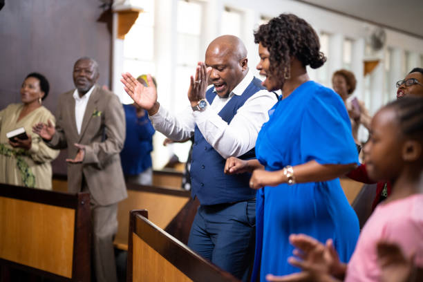 istock Side view congregation dancing and singing in church together 1484840074