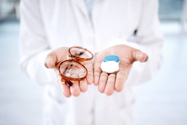 Eye care, choice with glasses or contact lens in hands, closeup and vision with healthcare for eyes. Prescription lenses, person with frame and plastic container, optometry with optician and health Eye care, choice with glasses or contact lens in hands, closeup and vision with healthcare for eyes. Prescription lenses, person with frame and plastic container, optometry with optician and health contact lens stock pictures, royalty-free photos & images