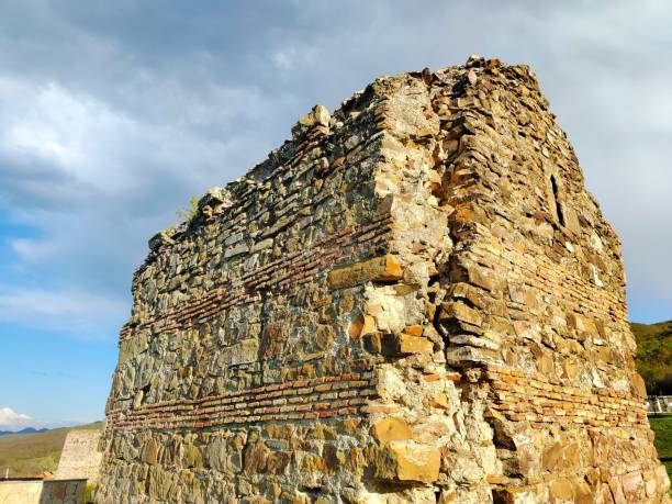 istock Aged brick building with several irregularly-shaped bricks protruding from the sides 1484840619