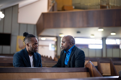 Pastor talks to gay man sitting in pew in church