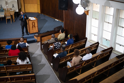 Multi-generation family and congregation enjoying church service