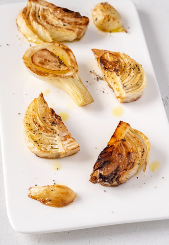 Sliced roasted fennel on the white plate