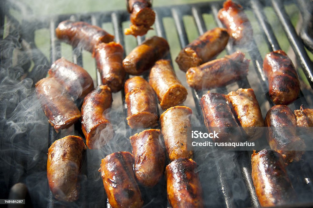 Grilling Out Grilling sausages for a picnic party Arts Culture and Entertainment Stock Photo