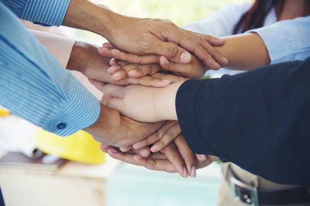 istock Close up hands Diverse multiethnic Partners team together. Teamwork group of multi racial people meeting join hands. Diversity people hands join empower partnership teams connect volunteer community 1484844522