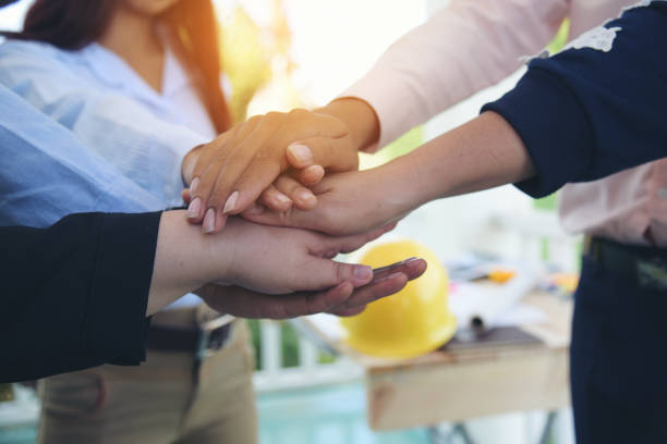 istock Diverse multiethnic Partners hands together teamwork group of multiracial people meeting join hands togetherness. Diversity people hands join empower partnership teams connection volunteer community 1484844542