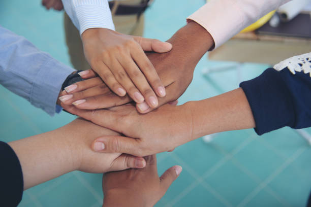 istock Close up hands Diverse multiethnic Partners team together. Teamwork group of multi racial people meeting join hands. Diversity people hands join empower partnership teams connect volunteer community 1484844546
