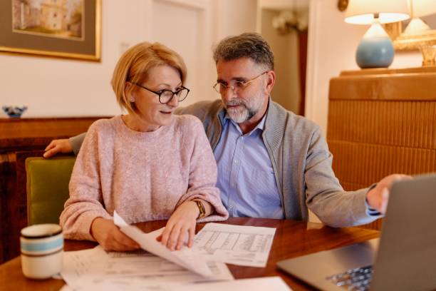 istock Productive man and a woman doing paperwork from home 1484845482