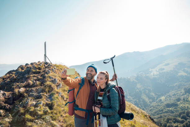 istock Mid adult couple taking a selfie while hiking on a mountain 1484847316
