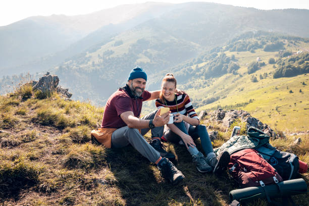 istock Mid adult couple taking a selfie while hiking on a mountain 1484847424