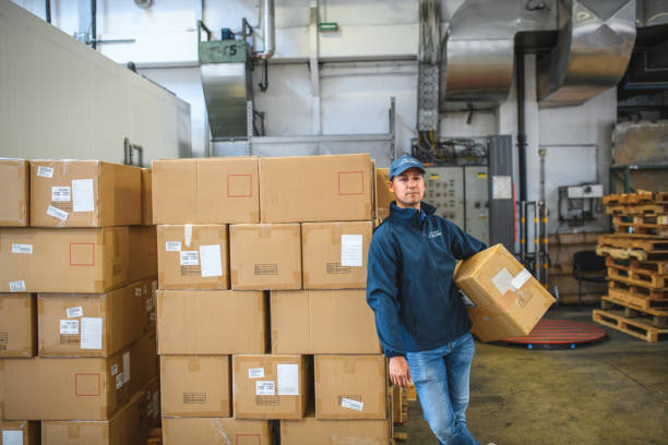 istock Asian Delivery Guy With Cardboard Package In Hands 1484850872