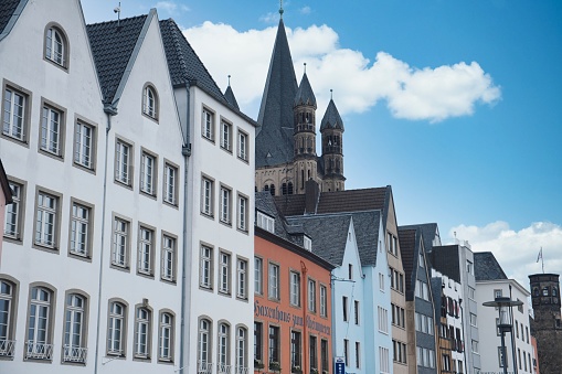 Cologne, Germany – March 28, 2023: typical colorful old houses next to the romanesque church Gross ST.Martin in the old town of cologne