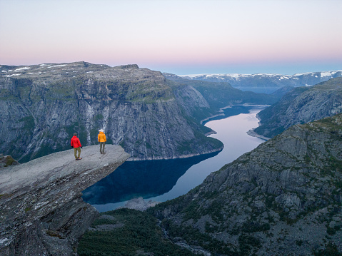 Magnificent view of the fjord and mountains at dawn, they stand on a hanging rock