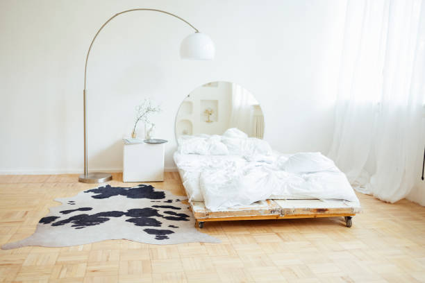 istock Double bed with white linens and square nightstand. 1484852756