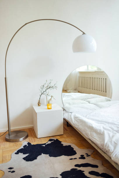Double bed with white linens and square nightstand.