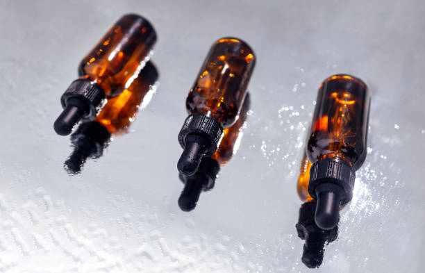 istock Group of bottles with drops on them and their reflection on a mirror surface 1484853219