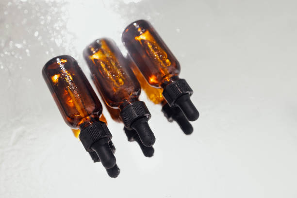 istock Group of bottles with drops on them and their reflection on a mirror surface 1484853266