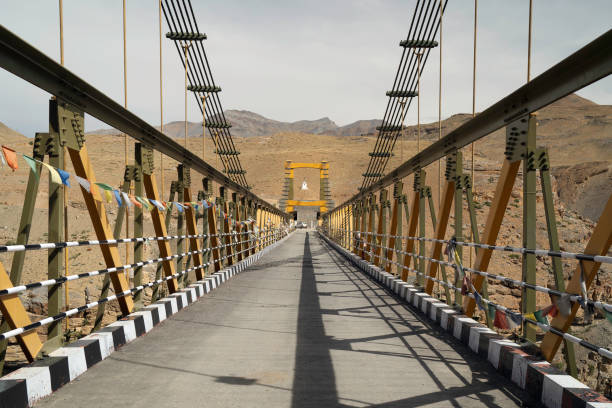 Suspension bridge spanning deep gorge over Spiti river and connecting villages of Kibber and Chicham near Chicham village, Himachal Pradesh, India.
