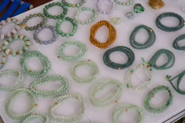 Photo of Close-up of various colorful gemstone bracelets and bracelets for sale in the market