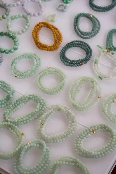 Photo of Close-up of various colorful gemstone bracelets and bracelets for sale in the market