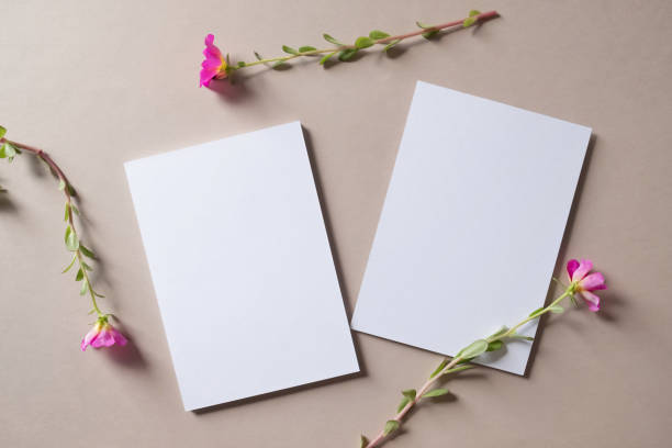 istock White blank greeting or invitation card and envelope with pink flower decoration. 1484860848
