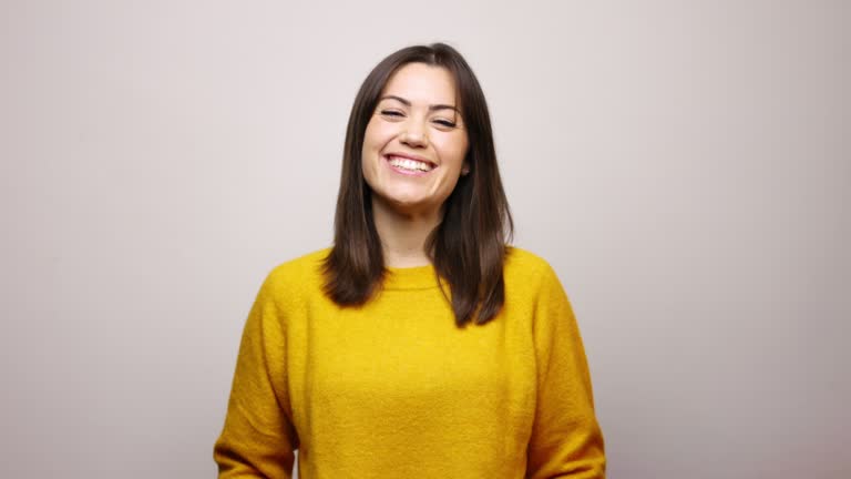 Happy beautiful woman wearing yellow sweatshirt