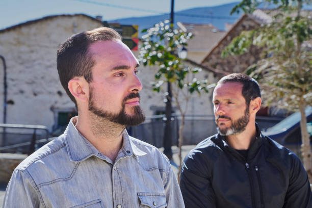 istock TWO MEN IN PROFILE, ONE ON EACH SIDE WITH THE SUN AGAINST 1484867583