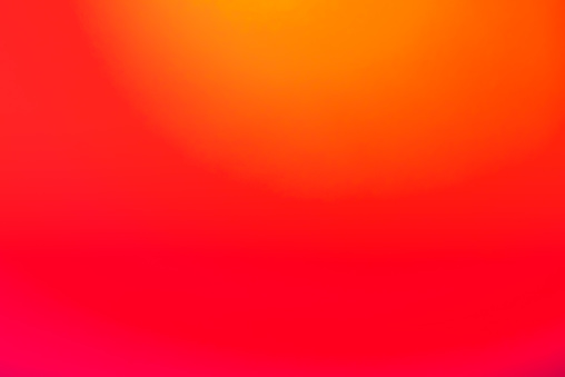 A red and orange color gradient, created by photographing colored light gel projections.