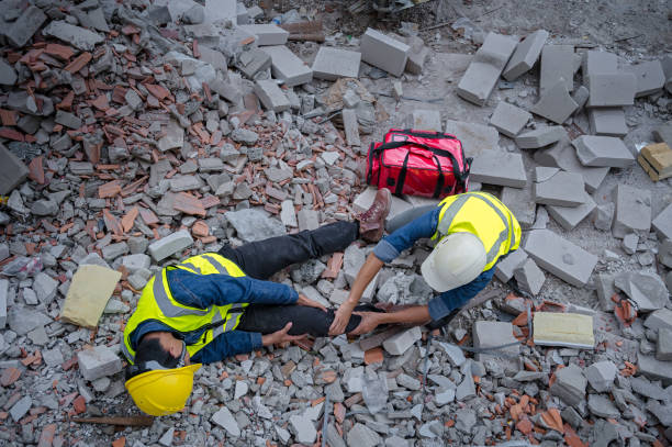 istock Young Asian builder falls from a height at a construction site. An engineer supervising the construction came to the aid of a construction worker who fell from a height with knee and leg injuries. 1484868388