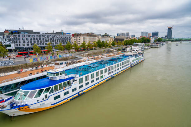 Bratislava, Slovakia - August 23, 2022: City skyline and ferry along Danube River.