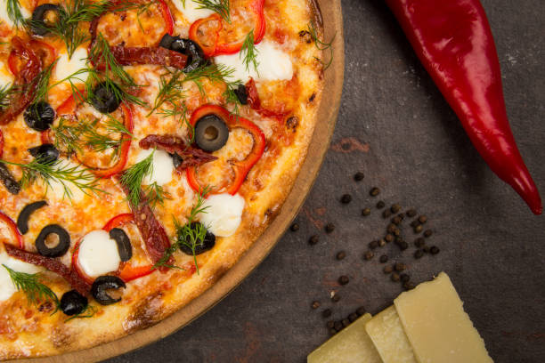 istock pizza with olive and cheese on the rusty background 1484871865
